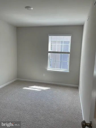 an empty room with a empty space and windows