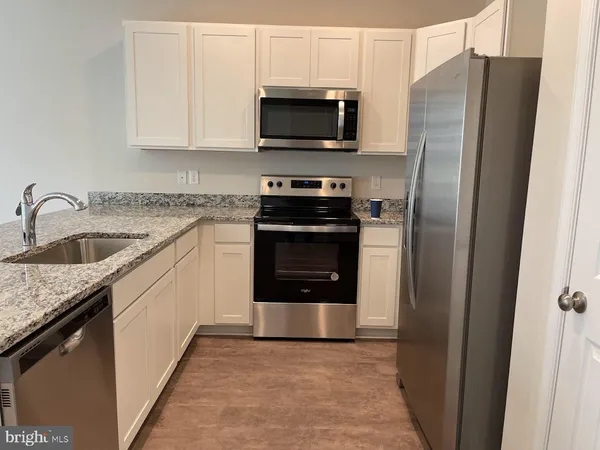 a kitchen with a stove microwave and sink