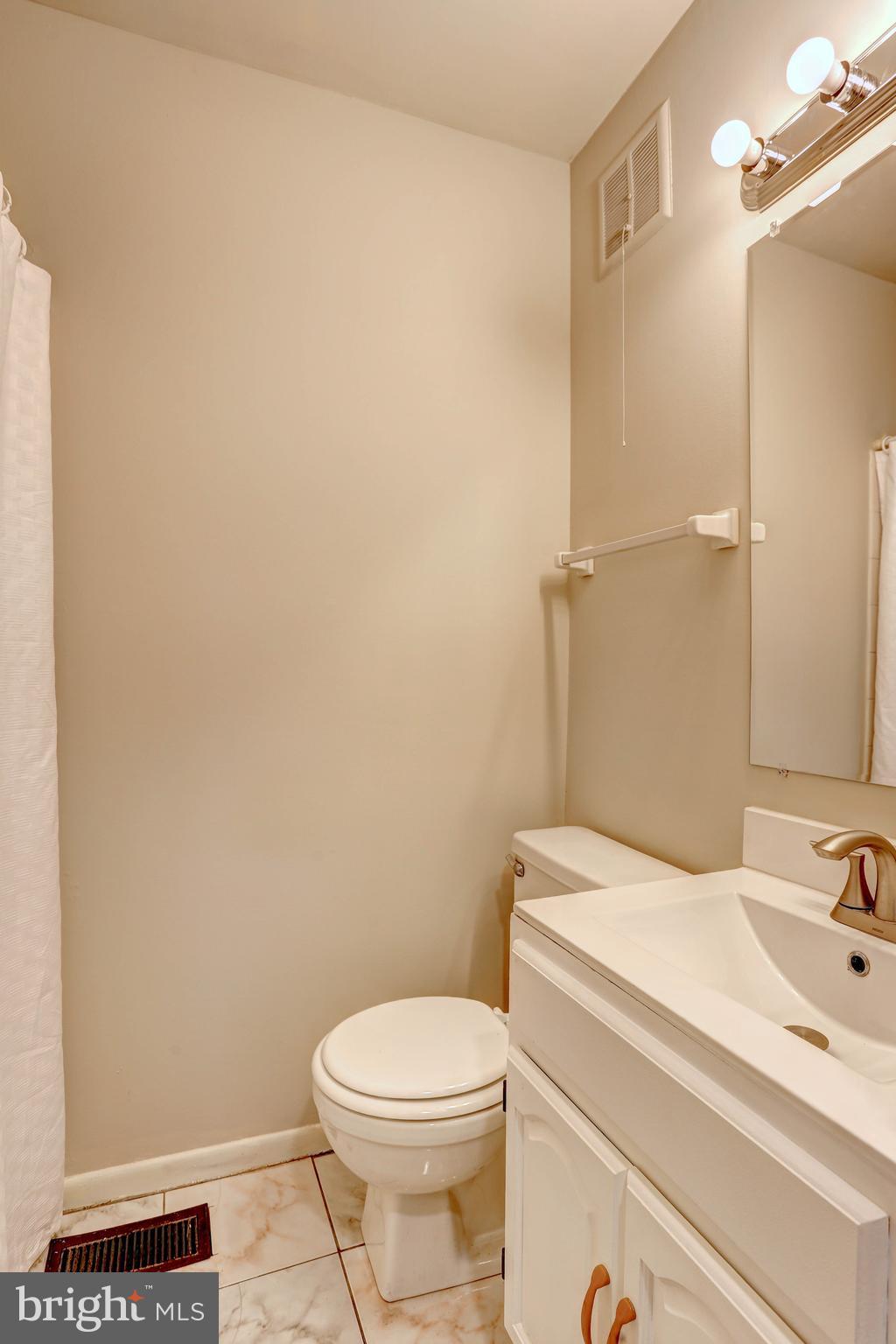 9110 Tumbleweed Run, Unit G Laurel, MD 20723 - Photo 11 of 32 a bathroom with a sink a toilet and shower