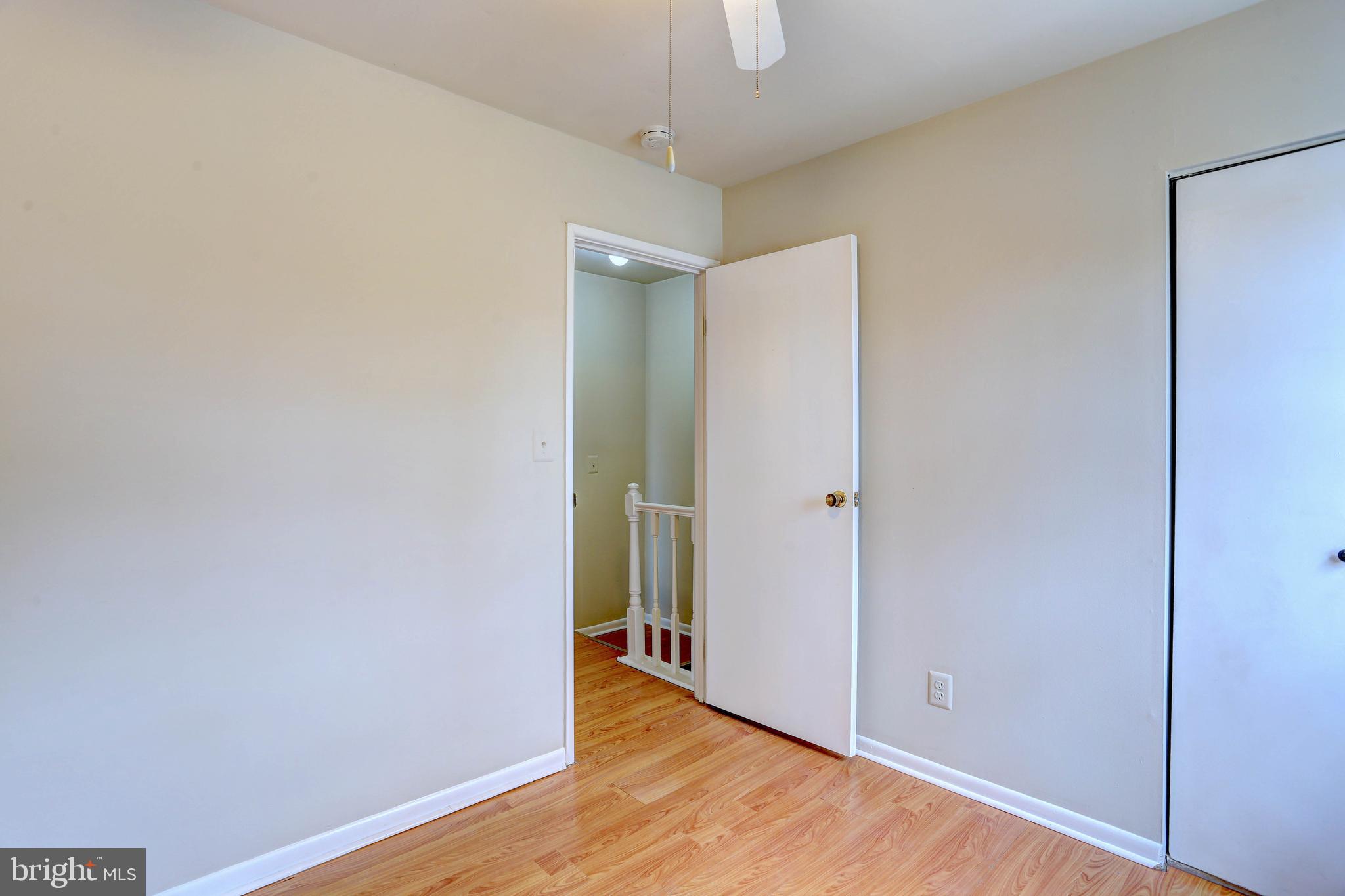 9110 Tumbleweed Run, Unit G Laurel, MD 20723 - Photo 13 of 32 a view of an empty room with wooden floor