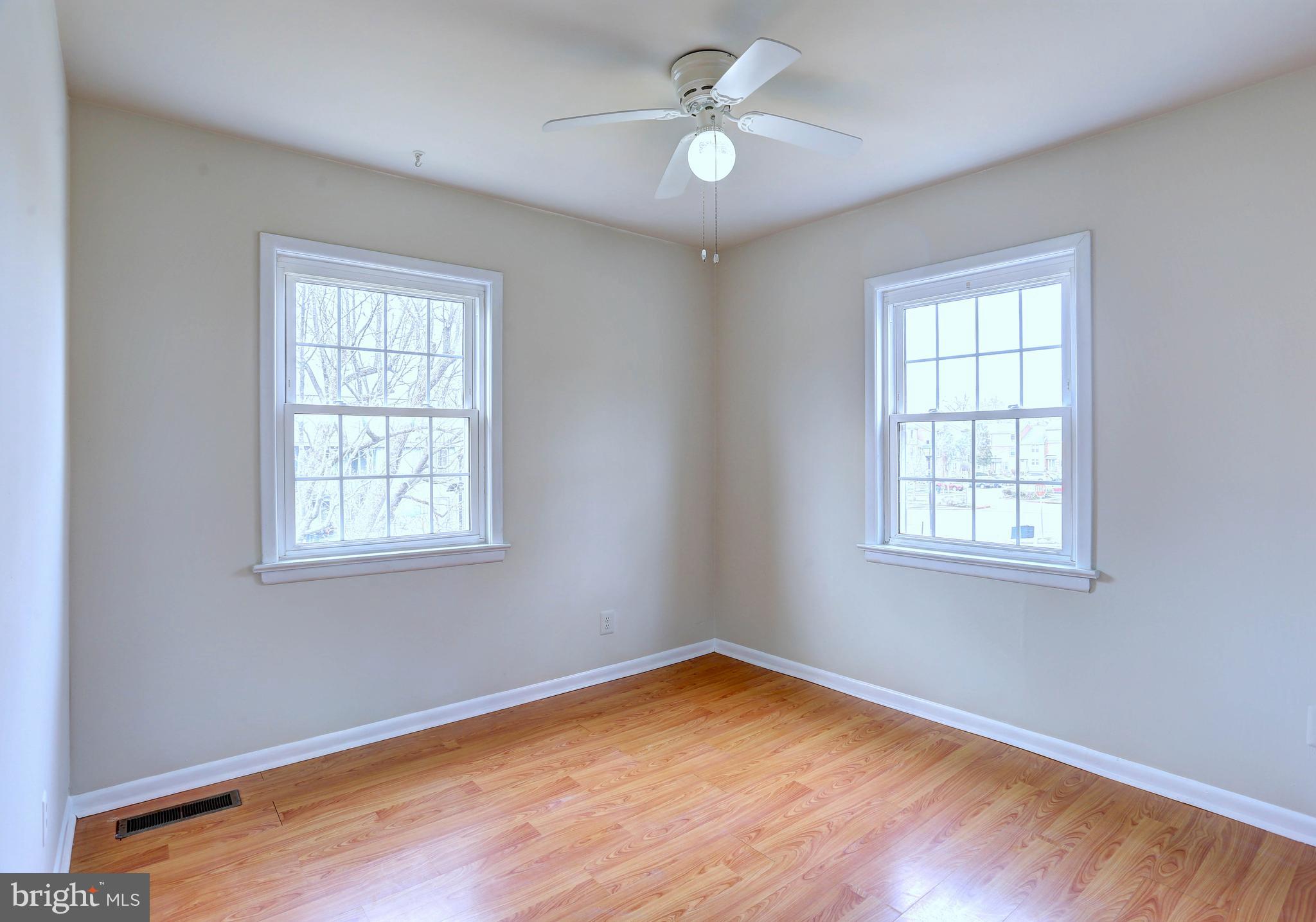 9110 Tumbleweed Run, Unit G Laurel, MD 20723 - Photo 16 of 32 a view of empty room with wooden floor and fan