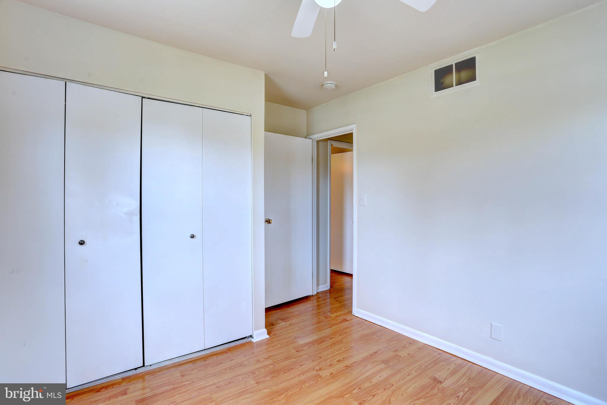 9110 Tumbleweed Run, Unit G Laurel, MD 20723 - Photo 17 of 32 a view of an empty room with wooden floor