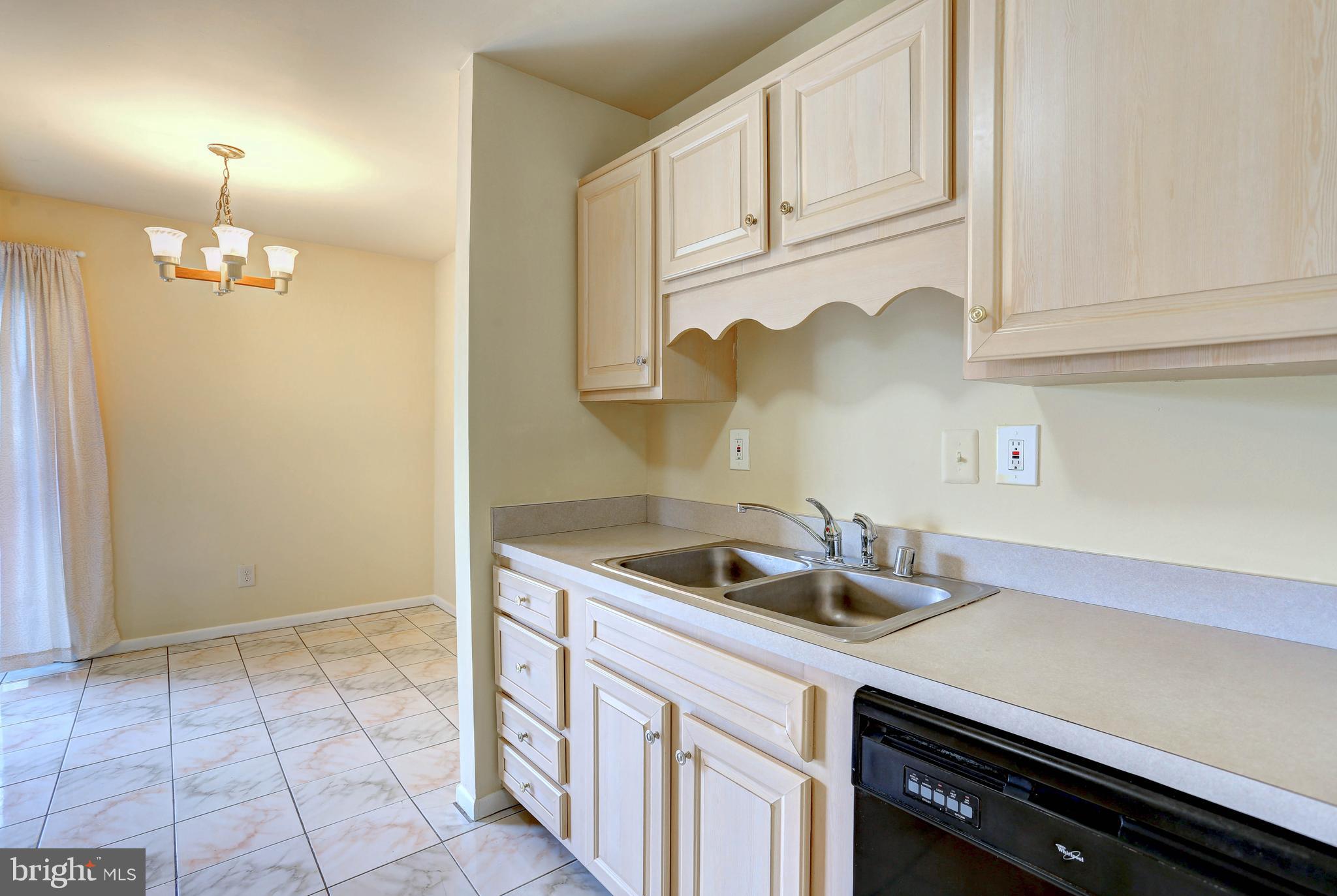 9110 Tumbleweed Run, Unit G Laurel, MD 20723 - Photo 9 of 32 a kitchen with a sink and cabinets