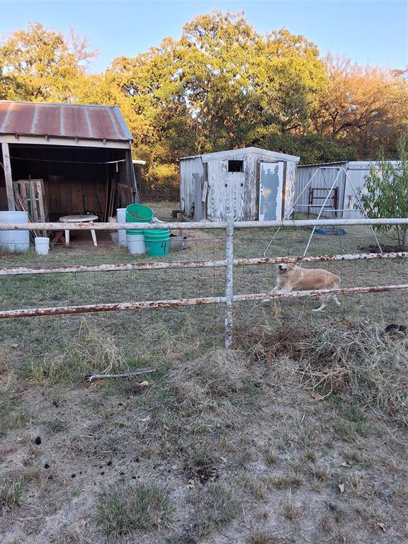 5765 Tokio Road West, TX 76691 - Photo 4 of 10 a backyard of a house with table and chairs