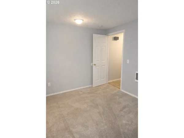 a view of an empty room with bathroom