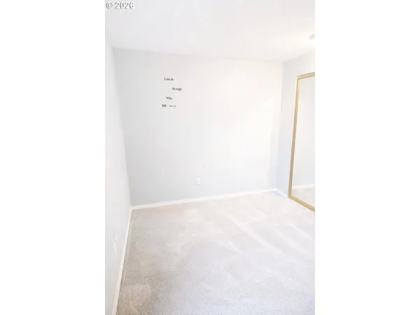 a bedroom with a bed and a night stand