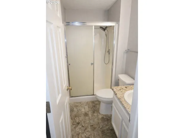 a bathroom with a toilet and shower