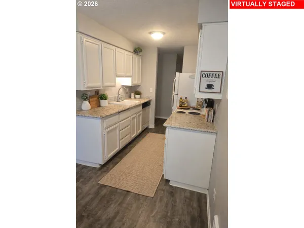 a room with a sink and a refrigerator