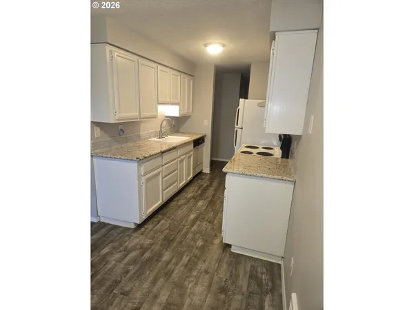 a view of a living room with a table and chairs