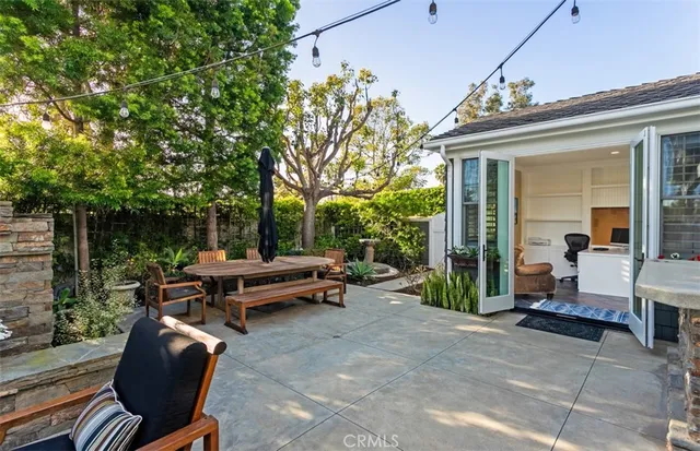 a view of a patio with table and chairs and potted plants