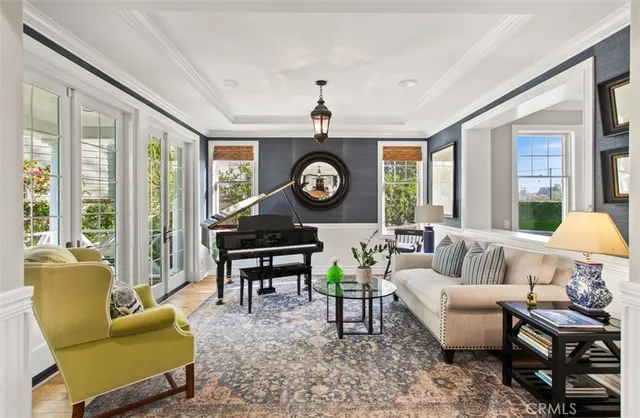 a living room with furniture a fireplace and a large window
