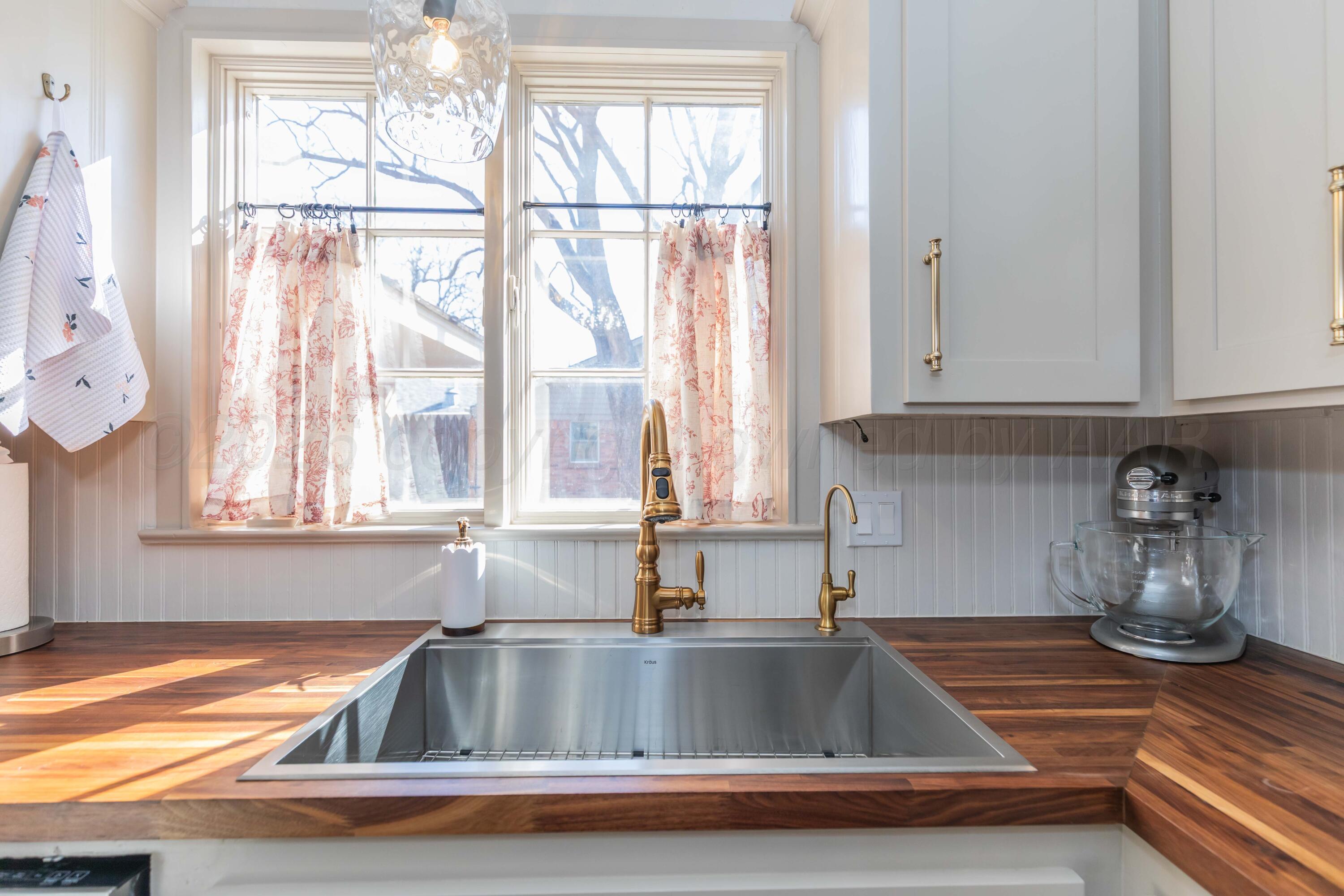 6308 Jameson Road Amarillo, TX 79106 - Photo 13 of 43 a kitchen with a sink and chandelier