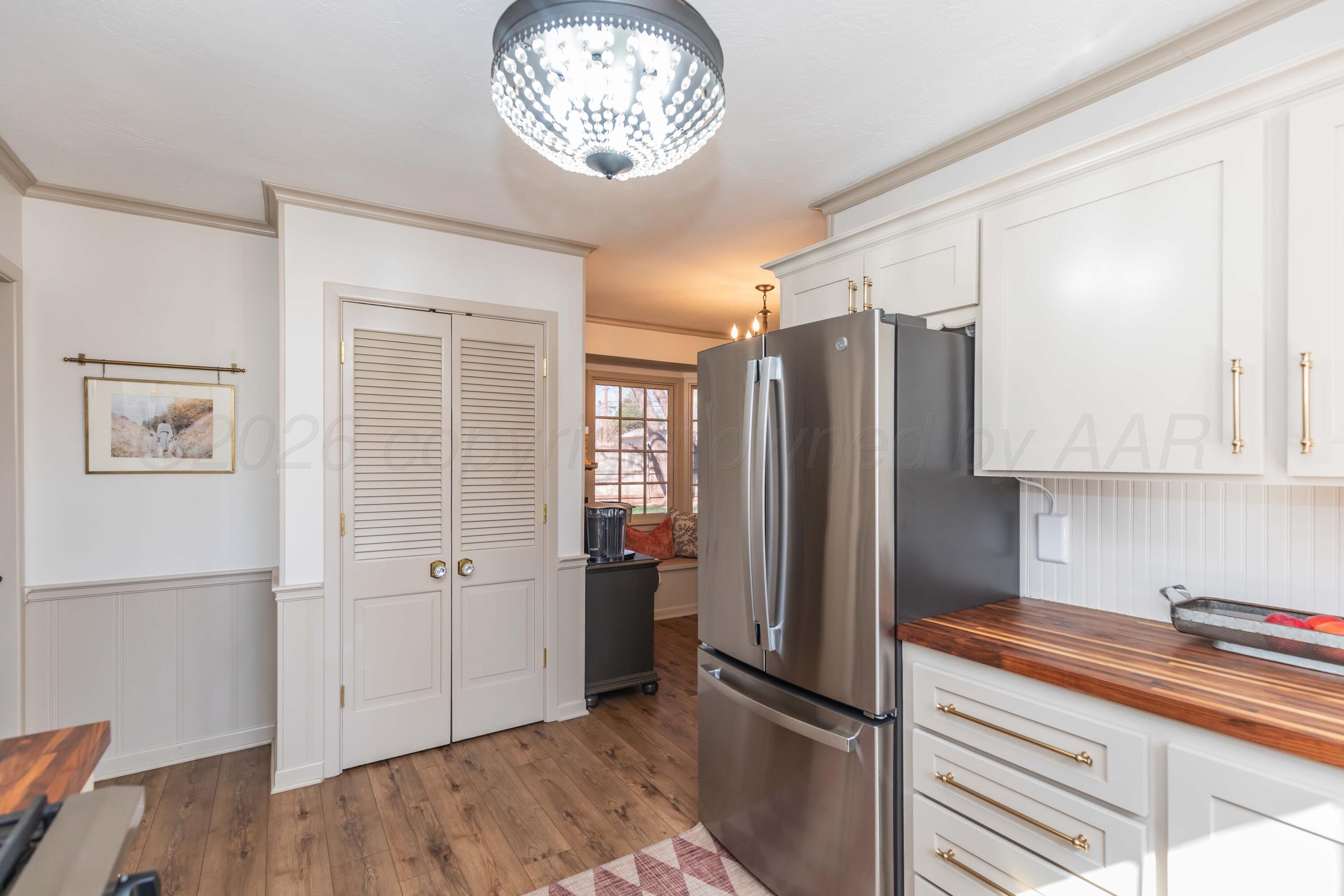 6308 Jameson Road Amarillo, TX 79106 - Photo 14 of 43 a kitchen with a refrigerator and a stove top oven