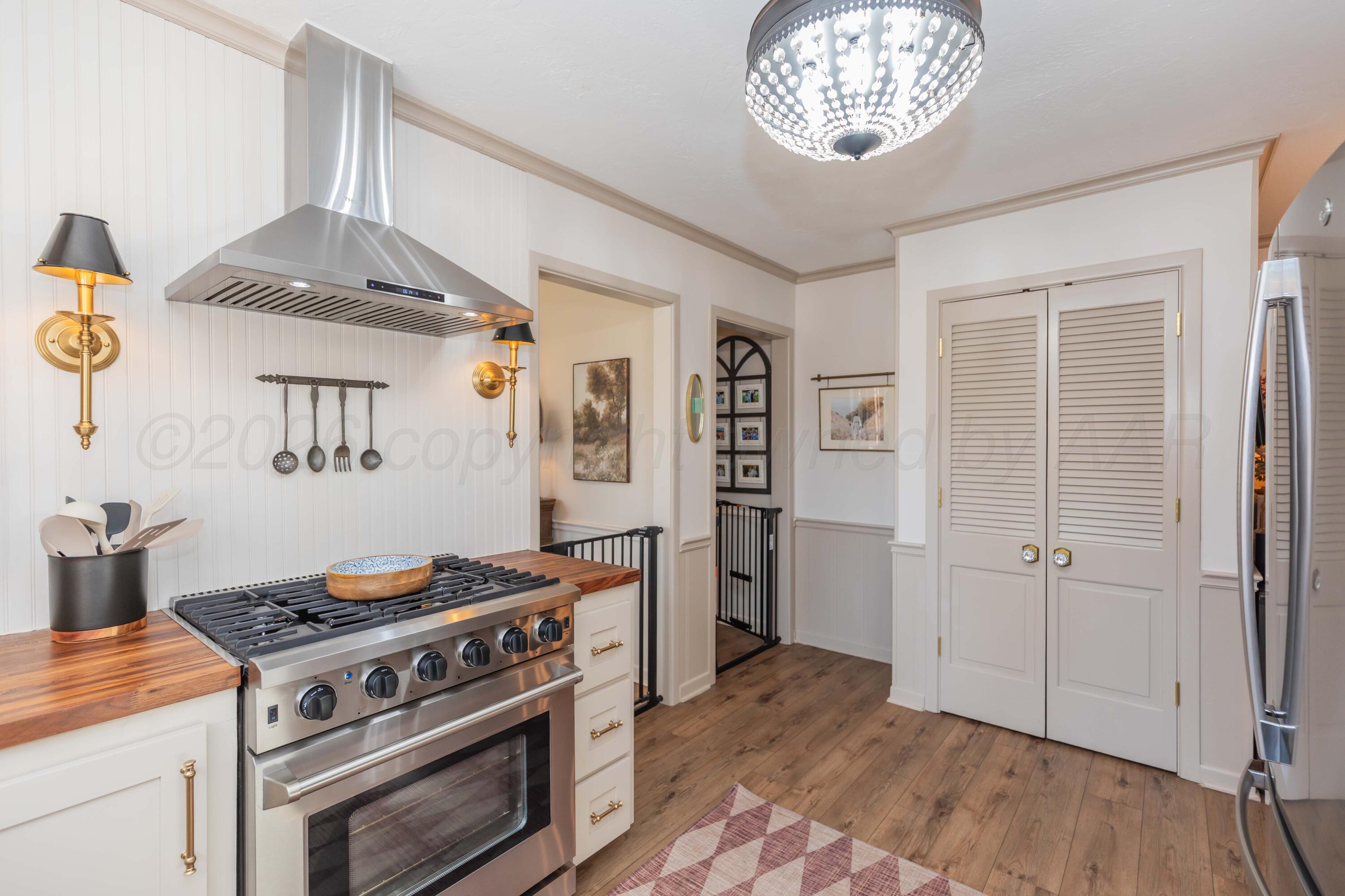 6308 Jameson Road Amarillo, TX 79106 - Photo 16 of 43 a kitchen with a stove and a refrigerator