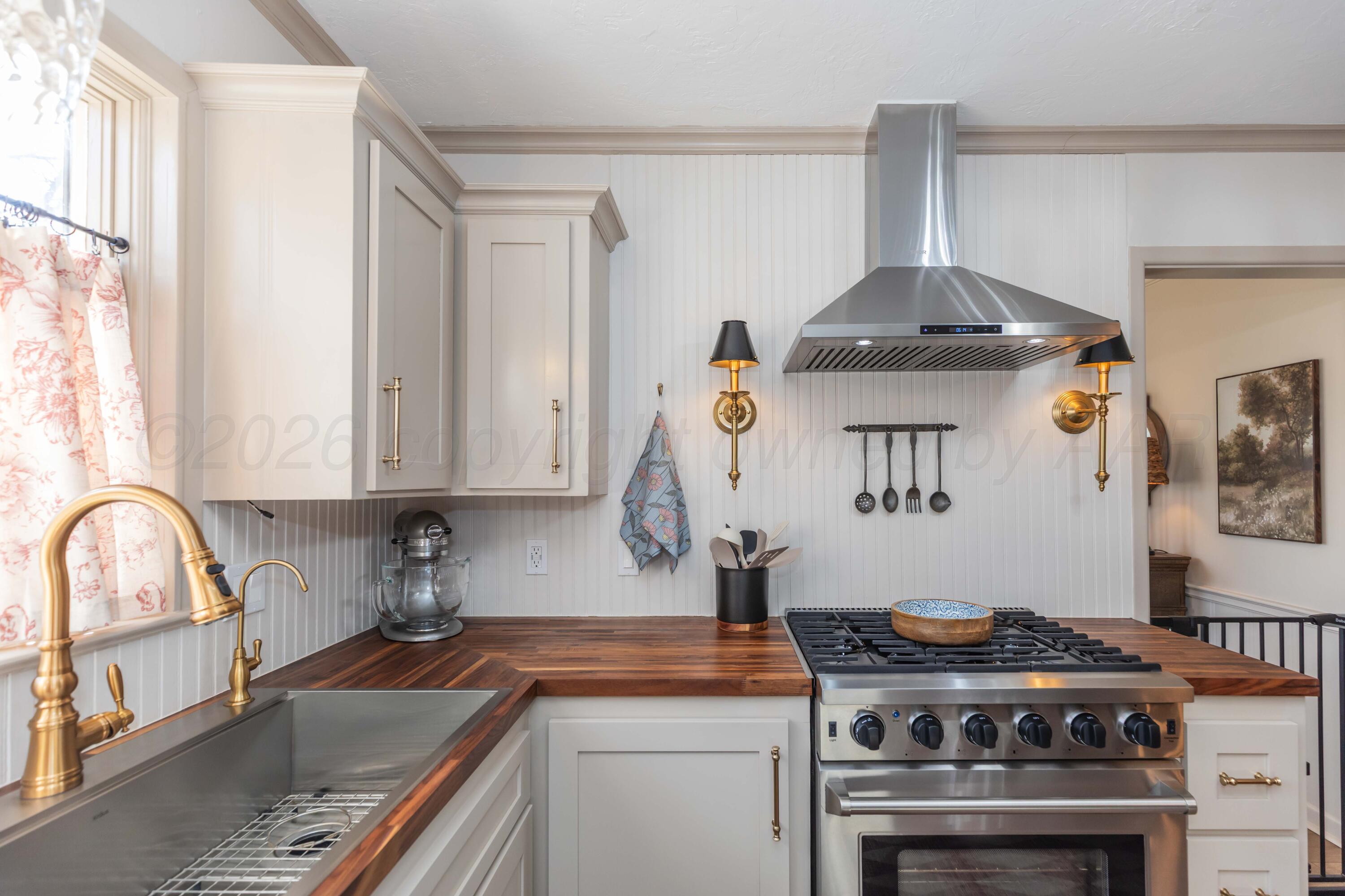 6308 Jameson Road Amarillo, TX 79106 - Photo 17 of 43 a kitchen with a stove and a sink