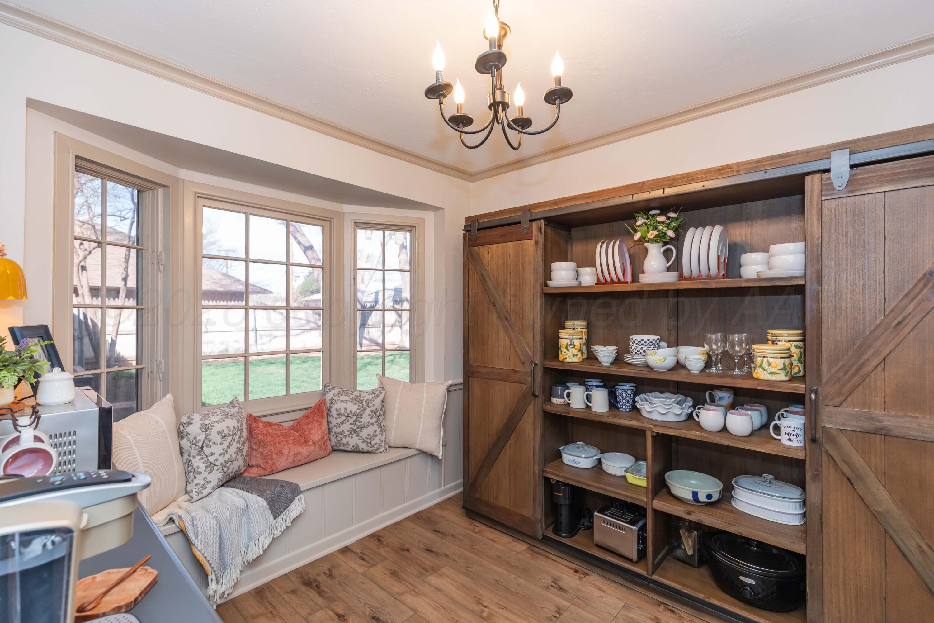 6308 Jameson Road Amarillo, TX 79106 - Photo 19 of 43 a living room with furniture a bookshelf and a window