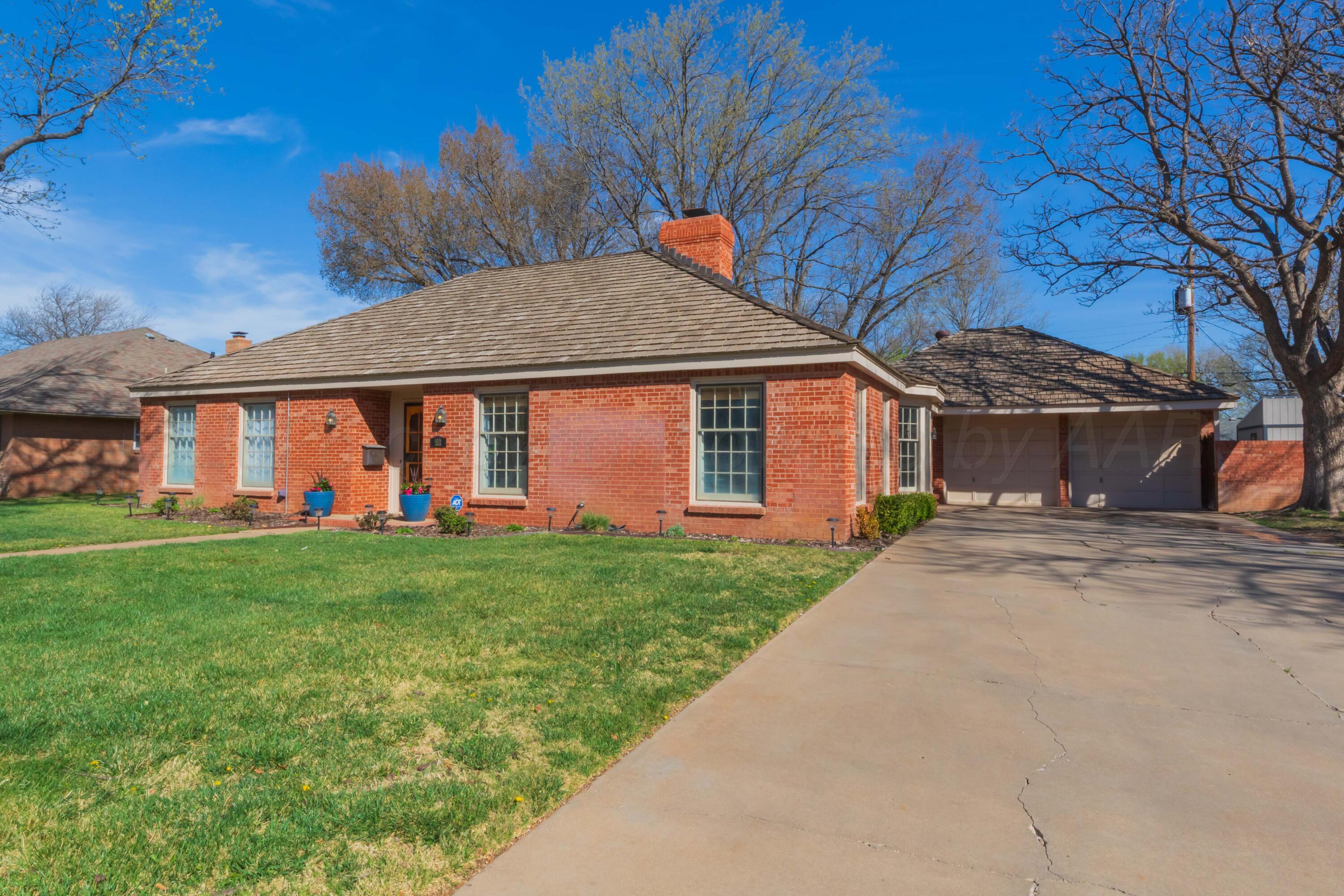 6308 Jameson Road Amarillo, TX 79106 - Photo 2 of 43 a front view of a house with a yard and garage