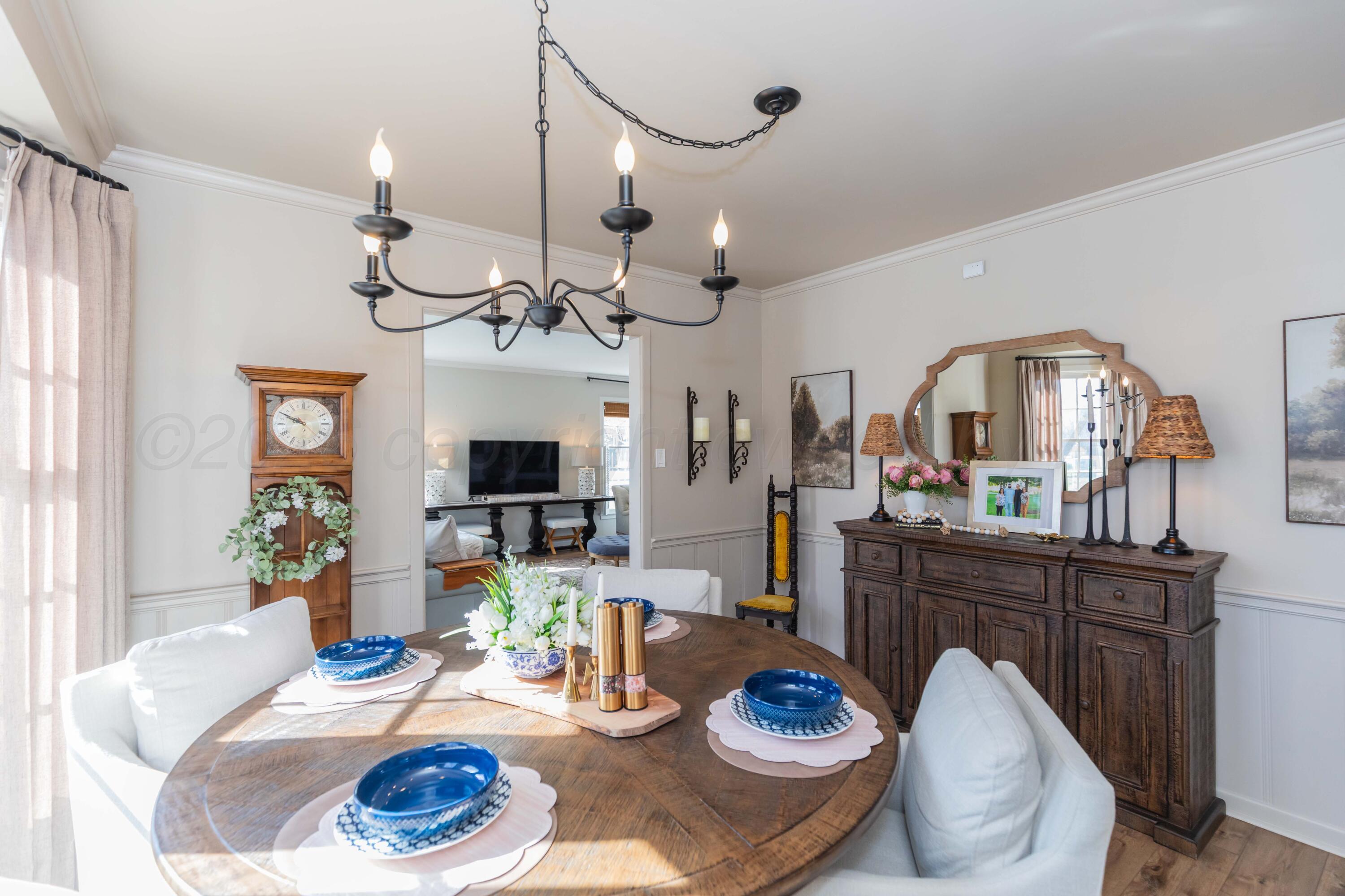 6308 Jameson Road Amarillo, TX 79106 - Photo 23 of 43 a dining room with wooden floor a chandelier a wooden table and chairs