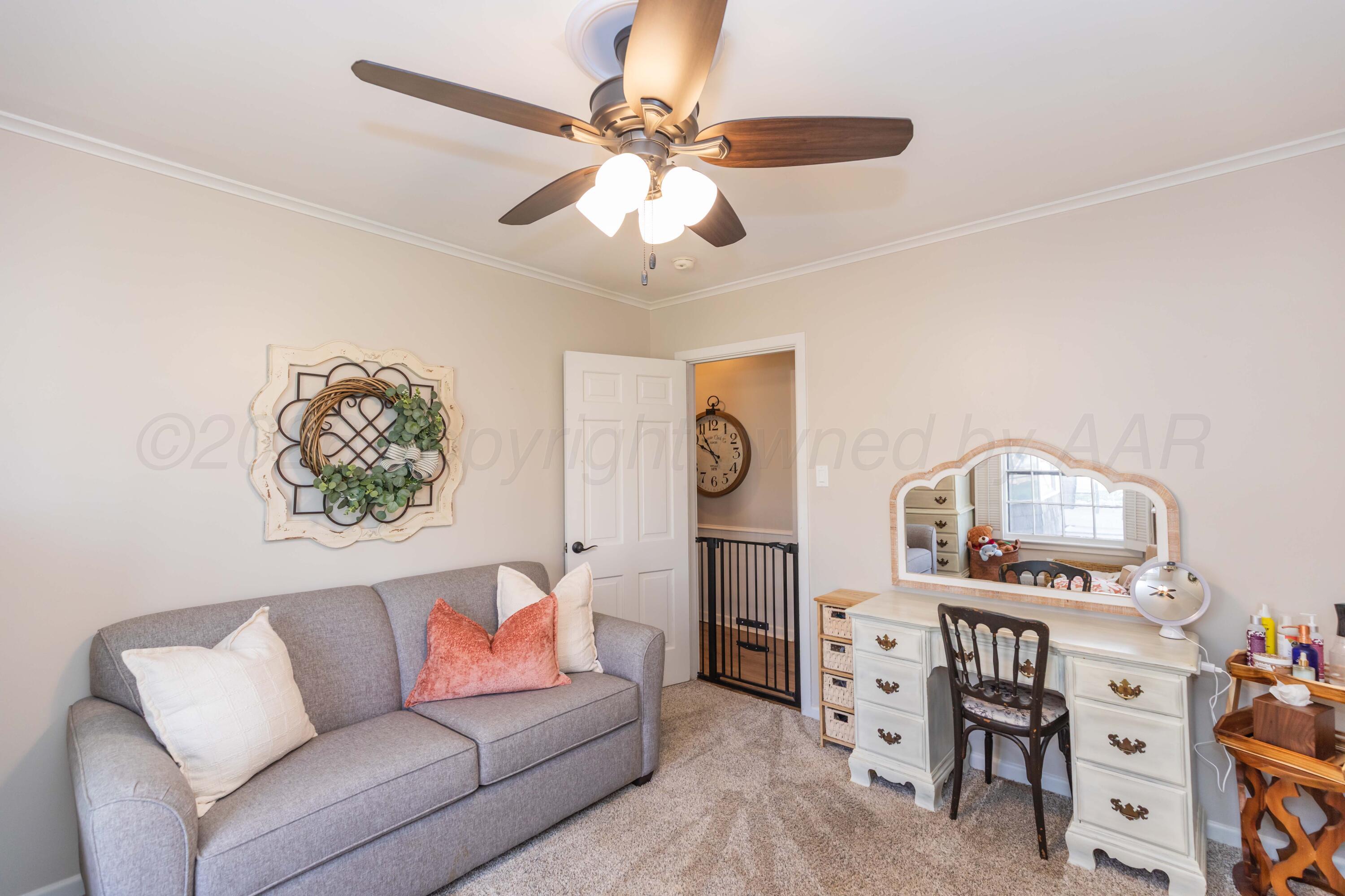 6308 Jameson Road Amarillo, TX 79106 - Photo 26 of 43 a living room with furniture and a chandelier