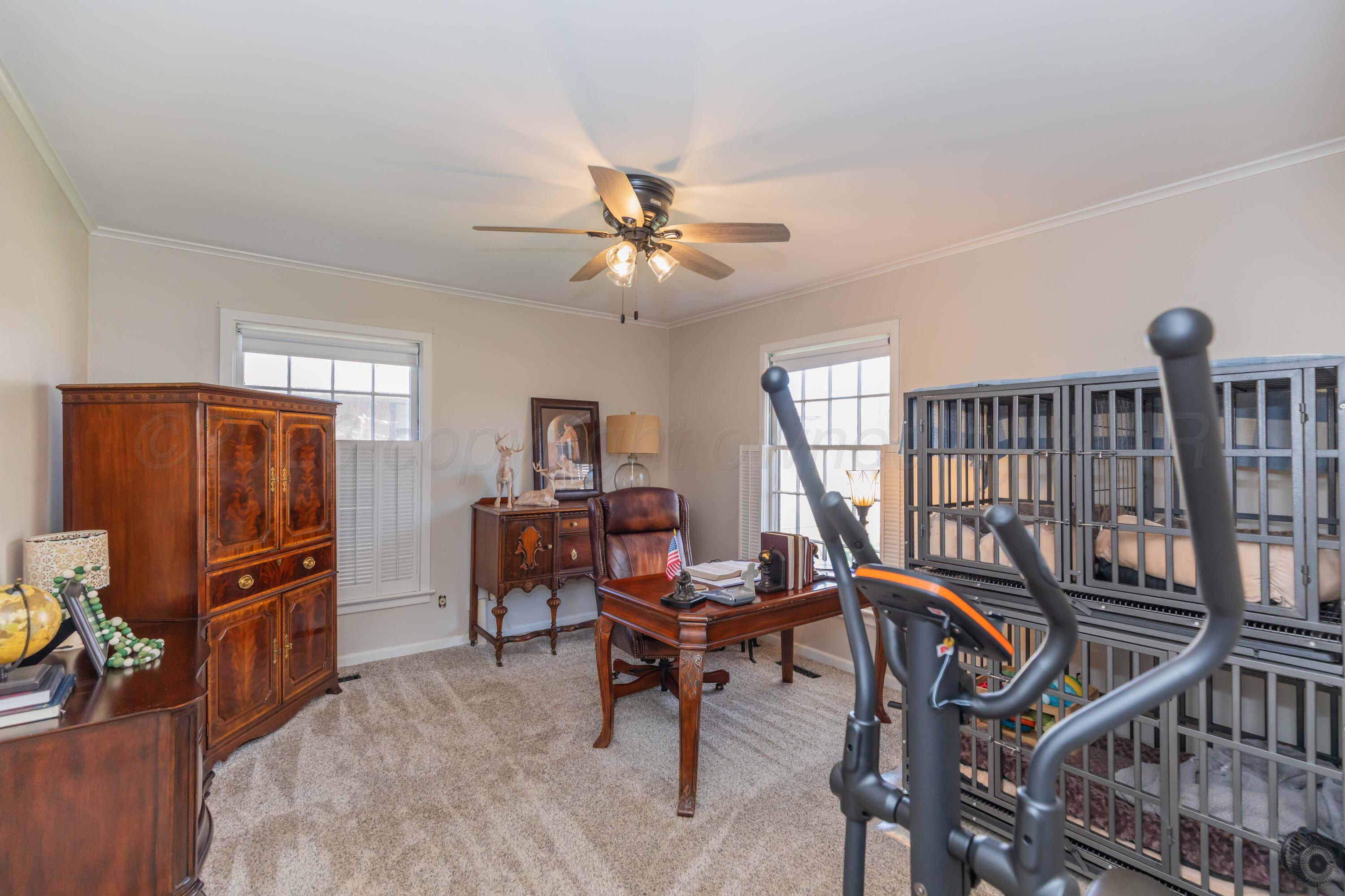 6308 Jameson Road Amarillo, TX 79106 - Photo 27 of 43 a living room with furniture a flat screen tv and a window