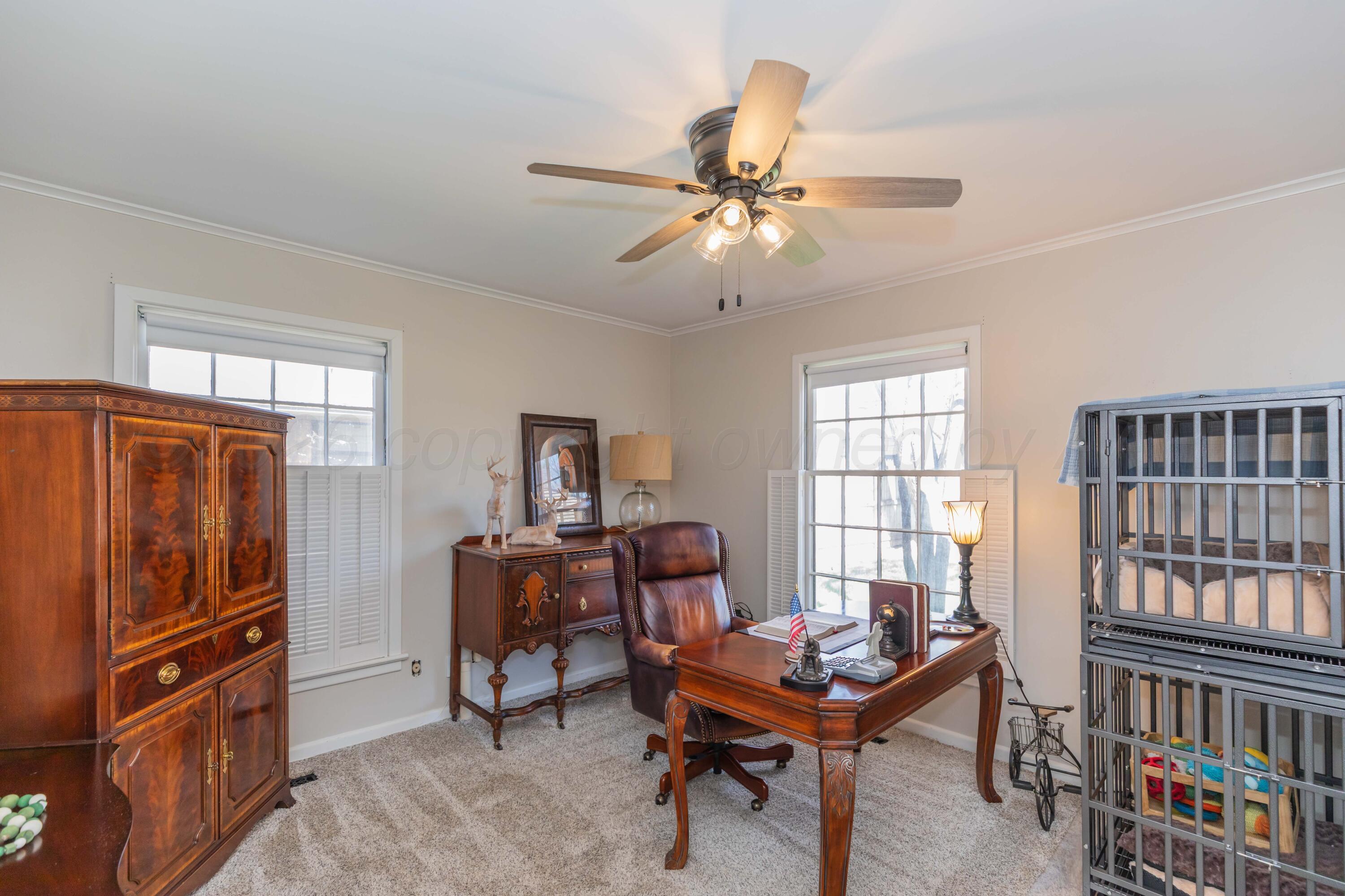 6308 Jameson Road Amarillo, TX 79106 - Photo 28 of 43 a living room with furniture a flat screen tv and piano table