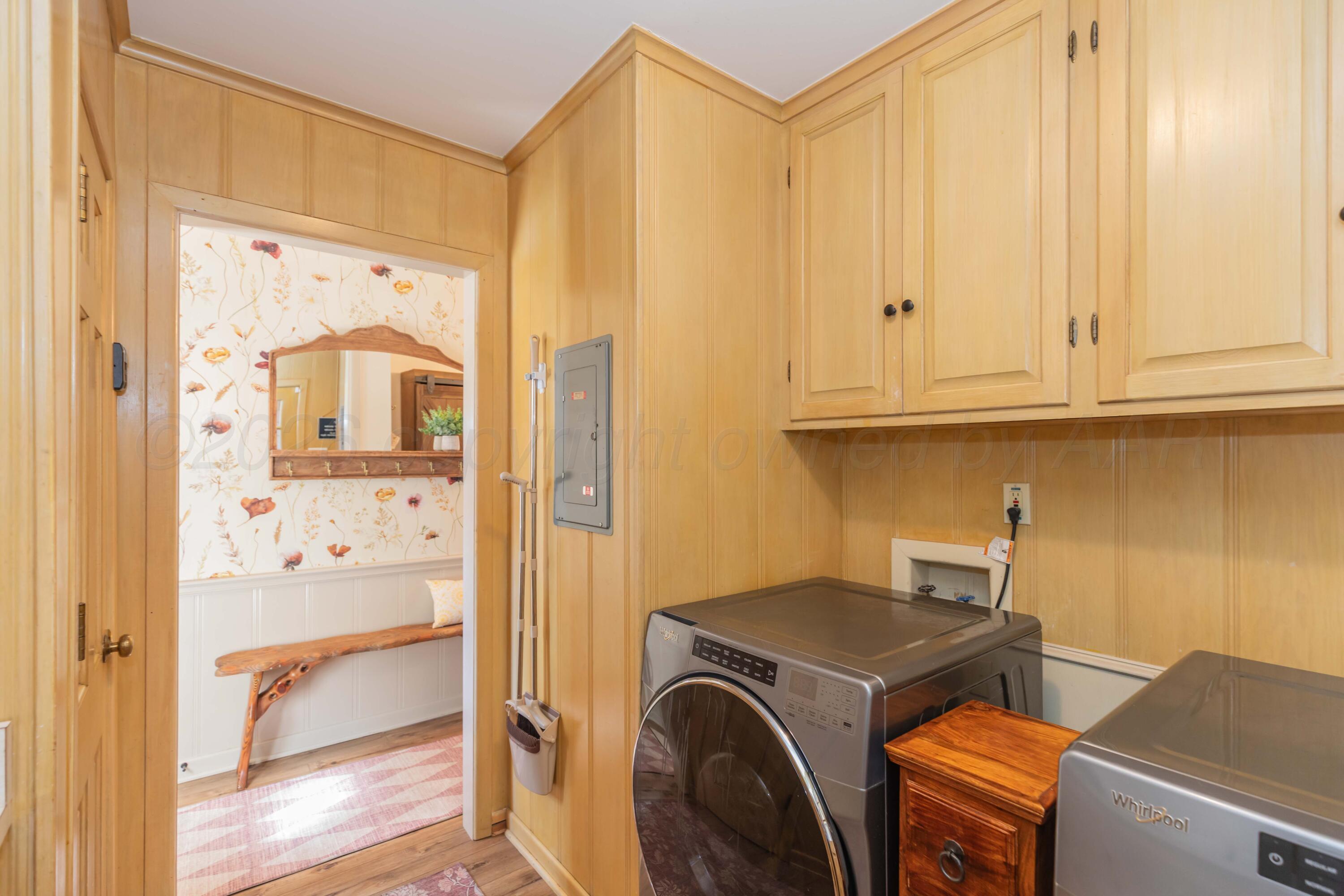 6308 Jameson Road Amarillo, TX 79106 - Photo 38 of 43 a view of storage and utility room with washer and dryer