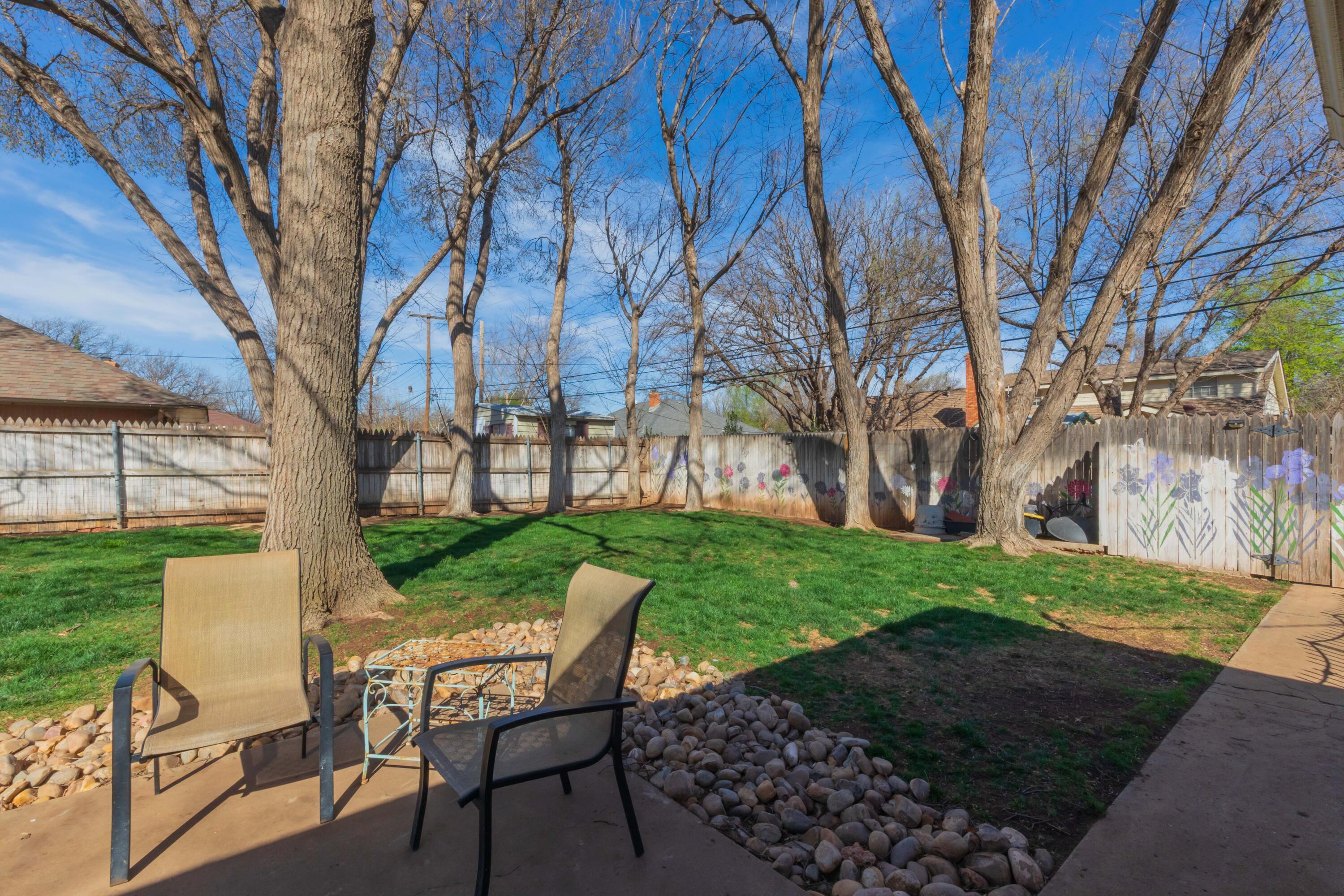 6308 Jameson Road Amarillo, TX 79106 - Photo 39 of 43 a view of a backyard with table and chairs and a tree