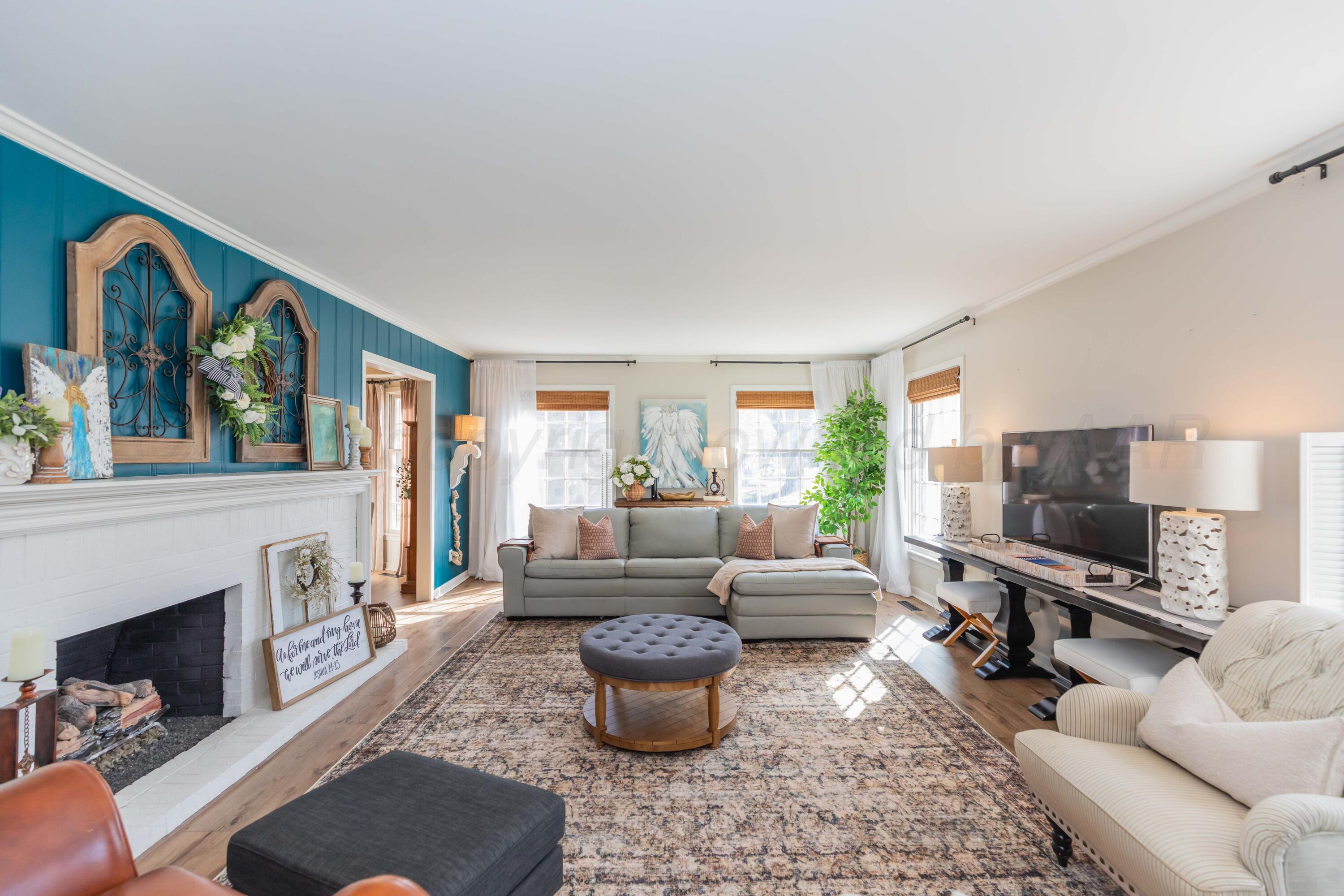 6308 Jameson Road Amarillo, TX 79106 - Photo 8 of 43 a living room with furniture fireplace and a flat screen tv