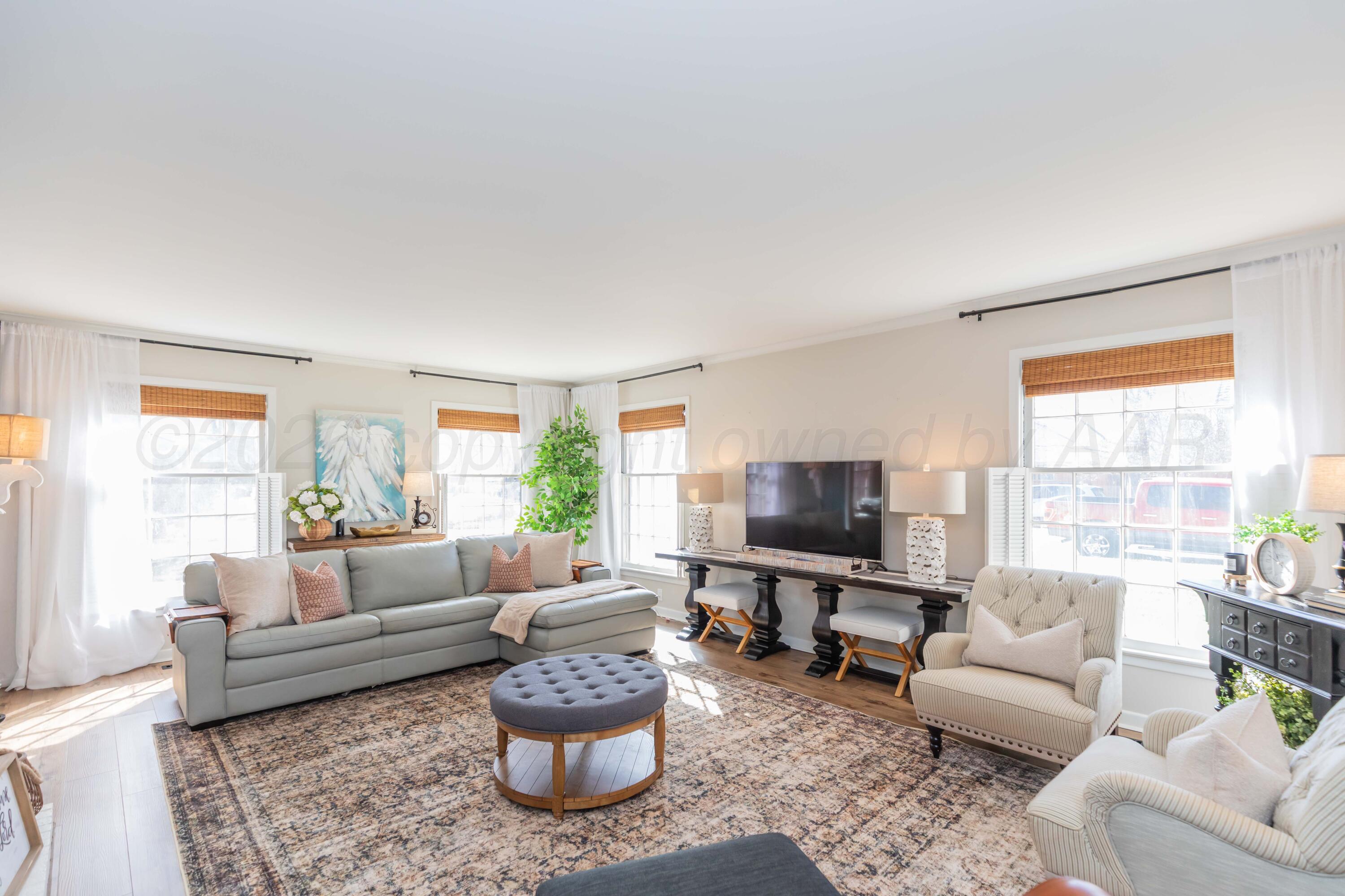 6308 Jameson Road Amarillo, TX 79106 - Photo 10 of 43 a living room with furniture and a flat screen tv