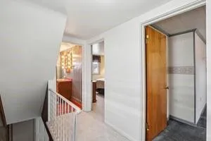 a view of hallway with wooden floor