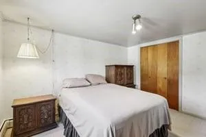 a bedroom with a bed and a night stand