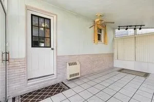a view of a hallway with couch and dining table