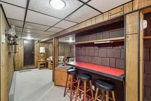 a kitchen with a table chairs and refrigerator
