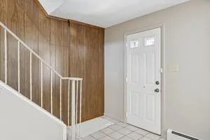 a view of a hallway with wooden floor and entryway