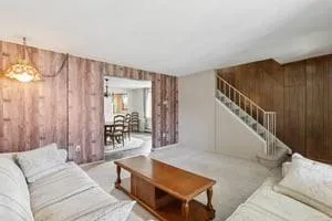 a living room with furniture and a chandelier