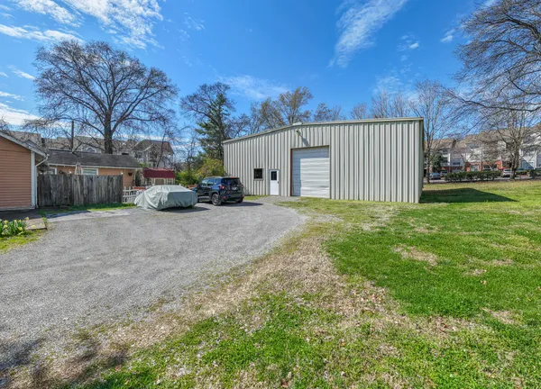 a view of a house with a yard and garage