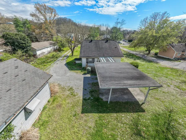 an aerial view of a house with a yard basket ball court and outdoor seating