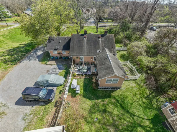 an aerial view of a house with garden space and street view