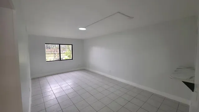 a room with a bed and a flat screen tv