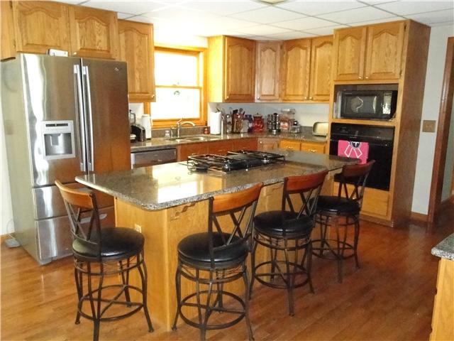 2386 Joe Brown Road Spring Hill, TN 37174 - Photo 19 of 20 Kitchen with island bar that seats four with granite on counter tops and built in desk
