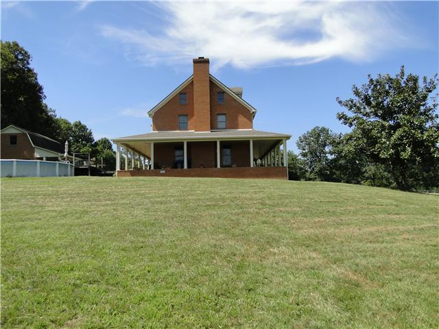 2386 Joe Brown Road Spring Hill, TN 37174 - Photo 4 of 20 East side of house with view of pool, barn and almost 1200 sq ft of wrap-around porch