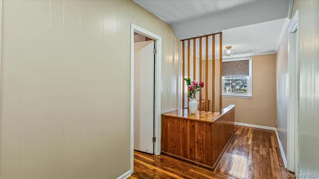 a view of a hallway with wooden floor and stairs