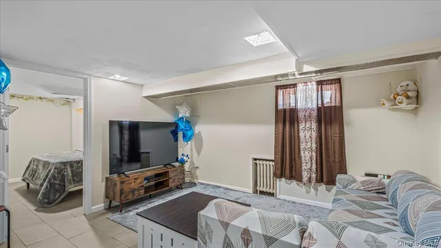 a bedroom with furniture and a flat screen tv