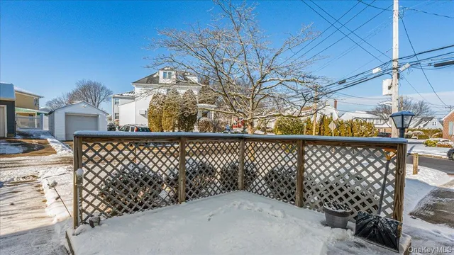 a view of a brick house with wooden fence