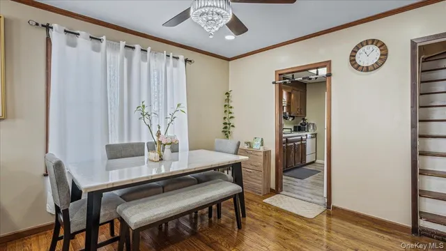 a view of a dining room with furniture and a chandelier