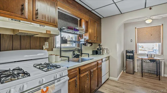 a kitchen with stainless steel appliances kitchen island granite countertop a sink stove and refrigerator