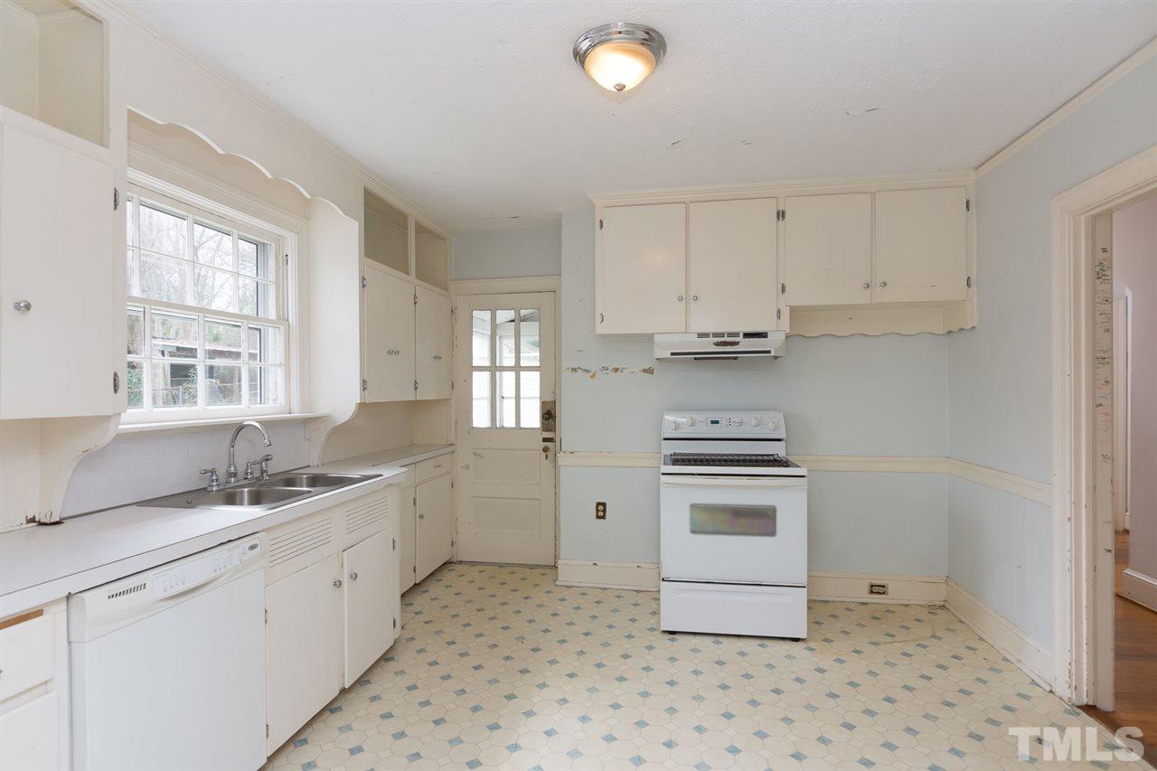 523 Elm Street Raleigh, NC 27604 - Photo 8 of 22 a kitchen with a stove a sink and a refrigerator