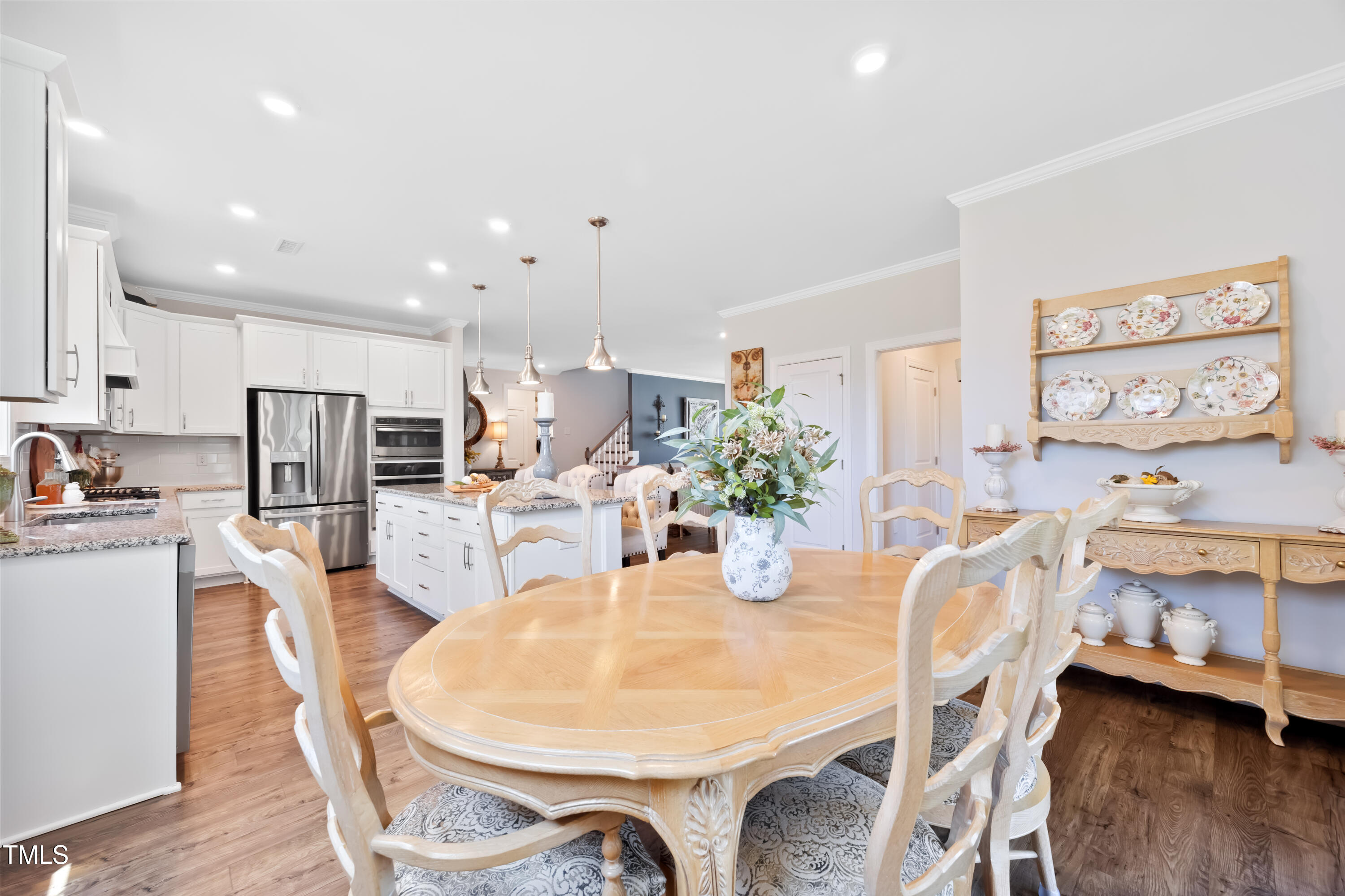 94 Two Creeks Loop Chapel Hill, NC 27517 - Photo 16 of 59 a dining room with furniture and a kitchen view
