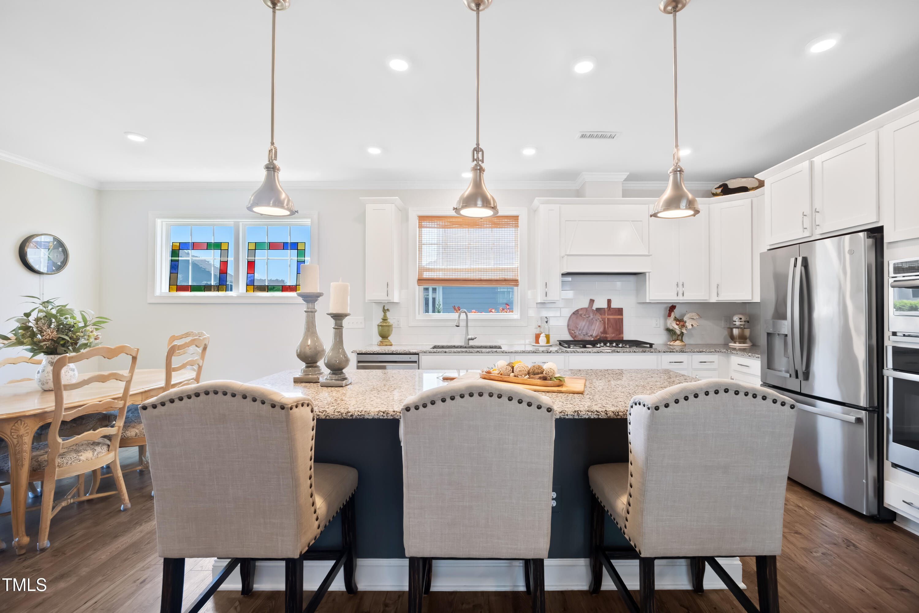 94 Two Creeks Loop Chapel Hill, NC 27517 - Photo 17 of 59 a kitchen with stainless steel appliances granite countertop a stove a sink a refrigerator a dining table and chairs
