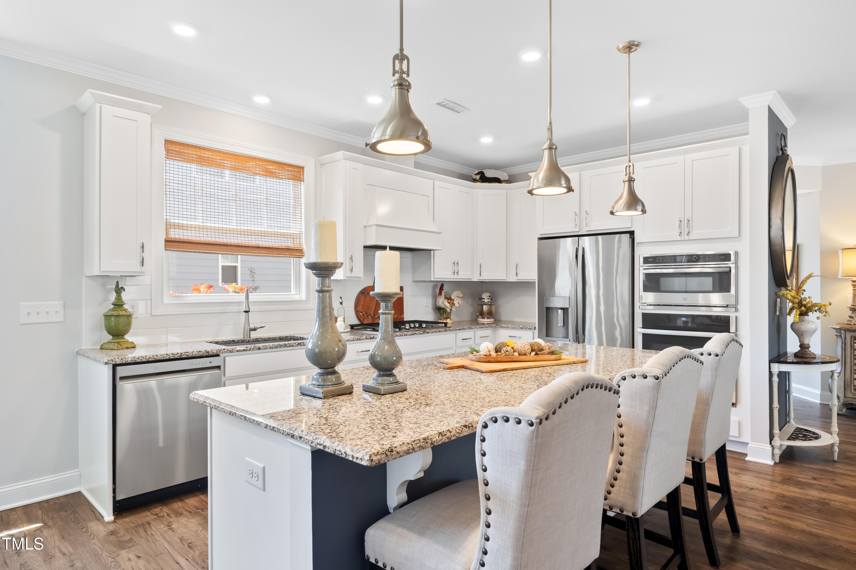 94 Two Creeks Loop Chapel Hill, NC 27517 - Photo 18 of 59 a kitchen with stainless steel appliances kitchen island granite countertop a dining table and chairs